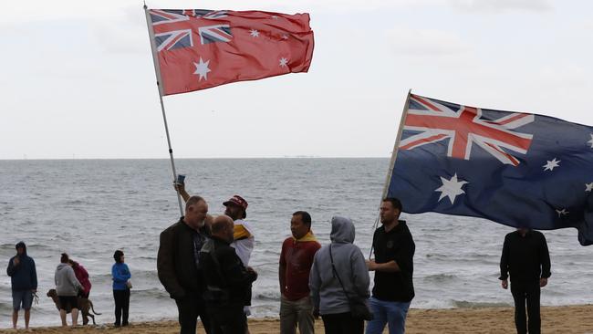 Flag-holders on St Kilda beach. Picture: Matrix