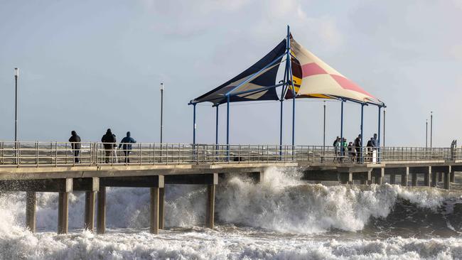 People watching the big waves on Brighton Jetty. Picture by Kelly Barnes