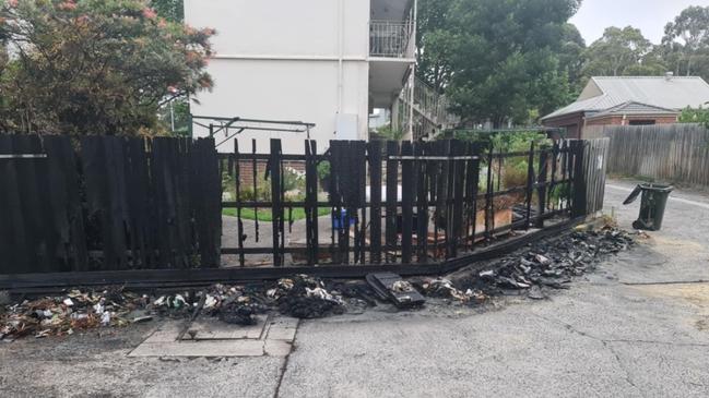 The fire charred the fence and melted the bins. Picture: Supplied.