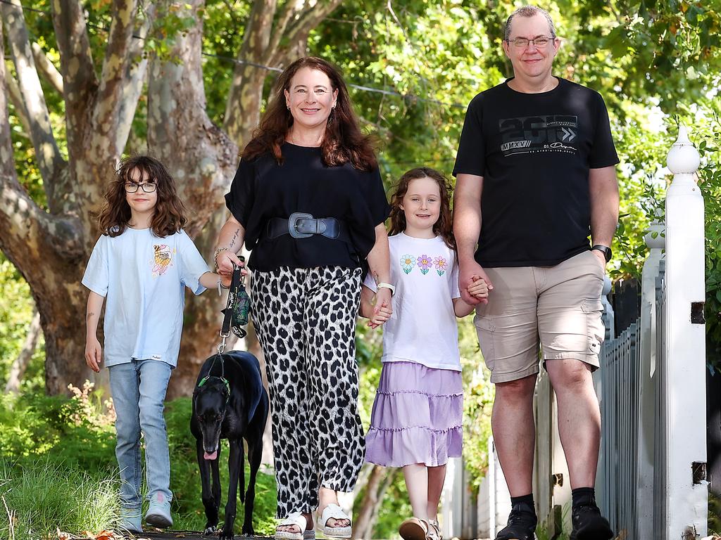 Megan and Nathan Martin, with their daughters Emma, 10, Chloe, 8 and Tavi the dog, love their neighbourhood of Flemington. Picture: Ian Currie