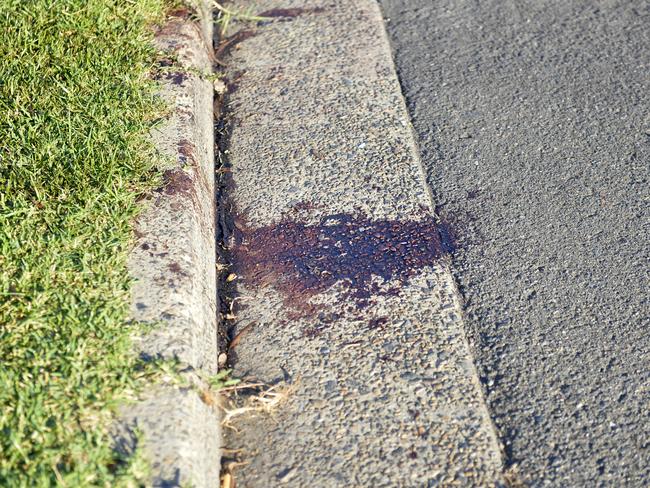 Bloodstains were visible on the roadside outside A-Team Body Works where the shooting took place. Picture: Jeremy Piper