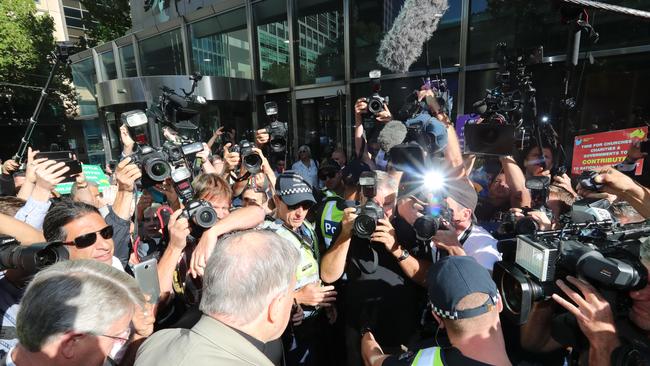 A throng of media and protesters surround Pell yesterday morning. Picture: Alex Coppel