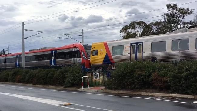 A diesel train pushes an electric train through the Brighton Rd intersection on Thursday. Picture: Dean Martin