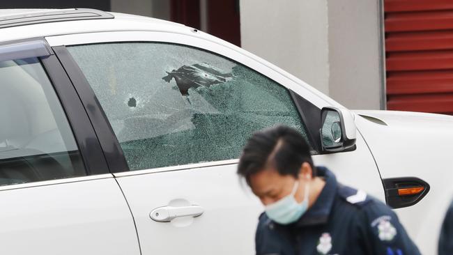 Police at the scene in Epping where multiple shots were fired into a car and house. Picture: David Crosling