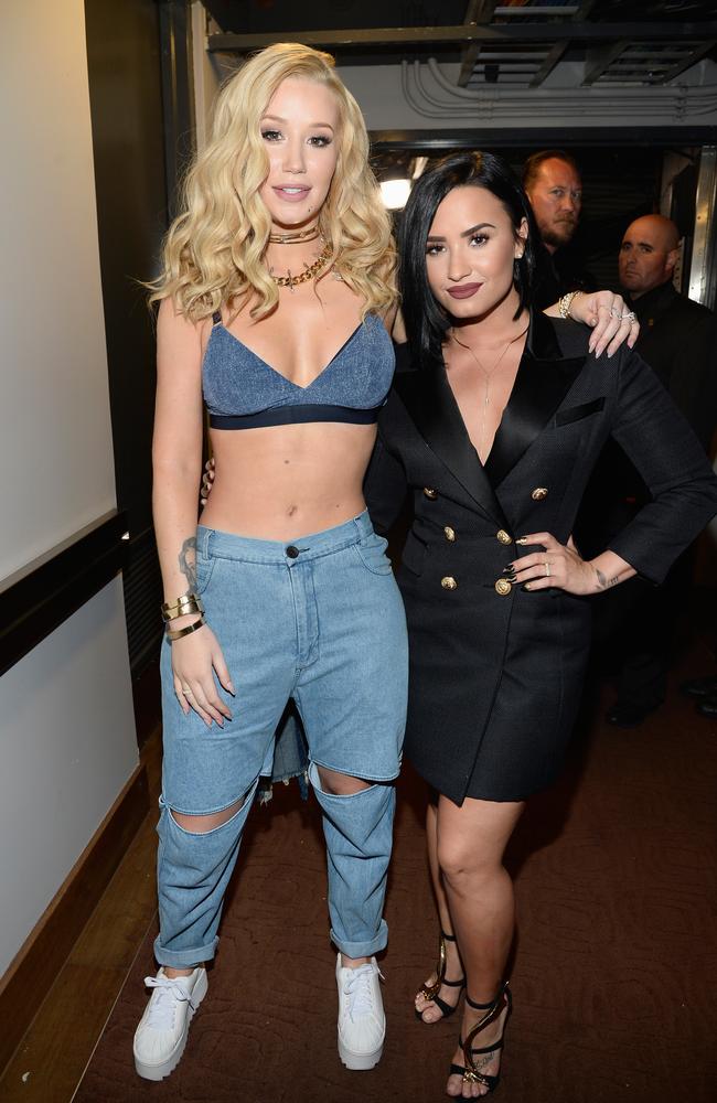 Iggy Azalea and Demi Lovato backstage at the iHeartRadio Music Awards. Picture: Getty