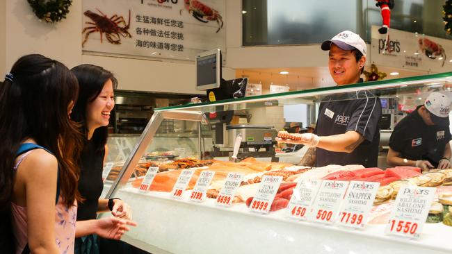 Shoppers Giewen Cheong and Melissa Mg check out the seafood at the Sydney Fish Market. Picture: Gaye Gerard