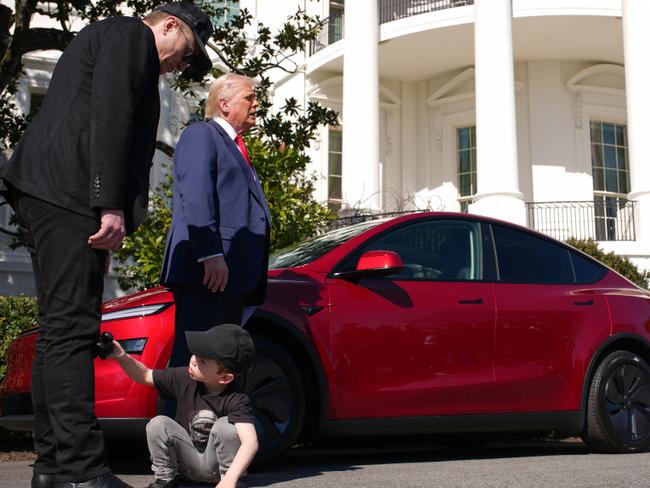 Mr Musk, Mr Trump and one of Mr Musk’s children at the event in question outside the White House. Picture: Andrew Harnik/Getty Images