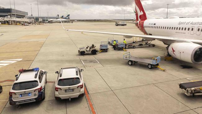 Police arrive at Melbourne Airport on Thursday to escort Mr Tito to the Melbourne Magistrates’ Court. Picture: Wayne Taylor