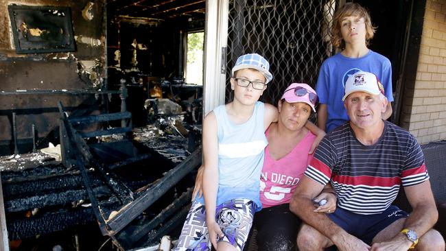 Parents Amanda and Matt with Jack and Kai the day after fire tore through their home. Picture: Martin Lange.