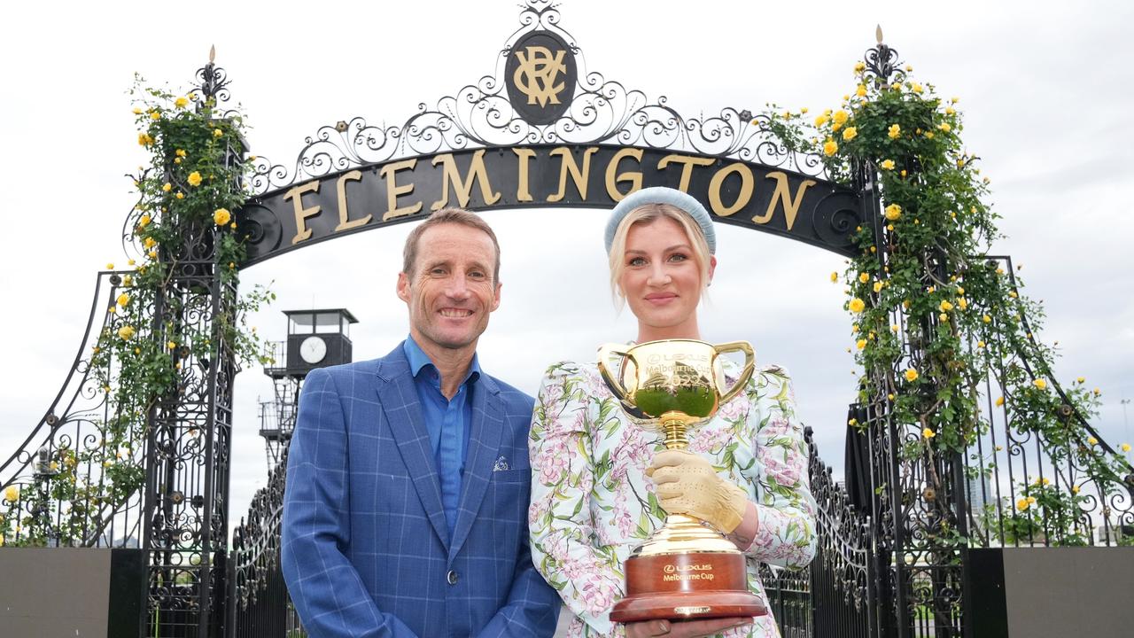 Damien Oliver and Jamie Kah pose with the Melbourne Cup. Photo by Scott Barbour/Racing Photos via Getty Images)