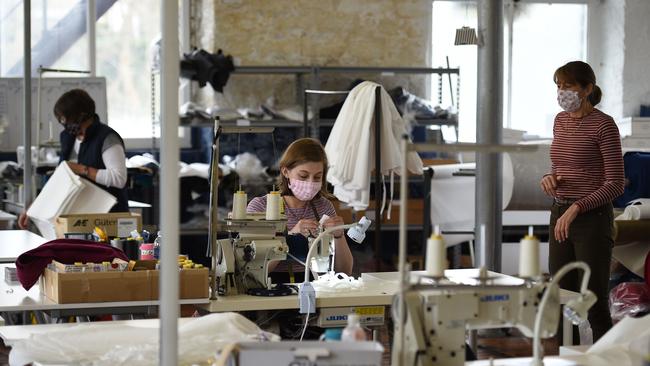 Machinists sew gowns at shirtmaker McNair, who have changed production to making gowns for the Huddersfield Royal Infirmary, in Slaithwaite, northern England.