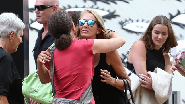 Tara Brown’s mother Natalie Hinton receives comfort by a supporter outside Brisbane Supreme Court.