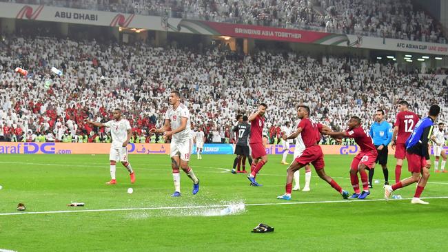 Fans throw bottles and flip-flops at the pitch during the 2019 AFC Asian Cup semi-final football match between Qatar and UAE. Picture: AFP