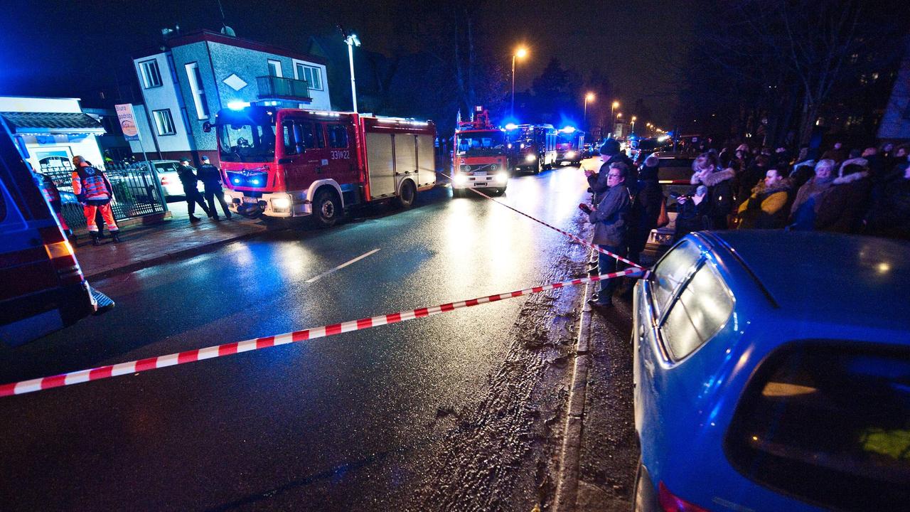 Police and firefighters at the scene where fire broke out in an escape room, killing five teenage girls, in northern Poland. Picture: Radoslaw Kolesnik/AFP