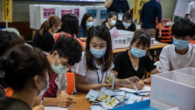 Volunteers on Saturday count ballots from a vote by students on whether to hold a citywide strike on the new national security bill. Picture: AFP