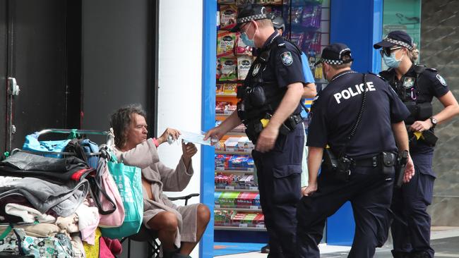 Police patrolling and handing out masks to those enduring homelessness in Surfers Paradise during a Covid-19 lockdown. Picture: Glenn Hampson.