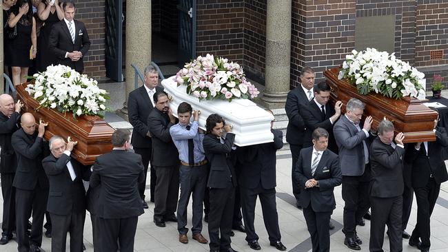 The coffins of Lars, Vivian and Annabelle Falkholt are carried from St Mary's Catholic Church. Picture: (AAP Image/Jeremy Piper