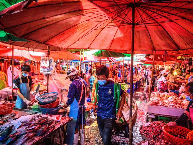 People crowd to buy meat and fish at Khlong Toei wet market despite fears of the spread of the COVID-19 coronavirus in Bangkok on April 14. Picture: AFP