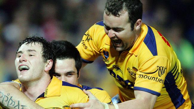 Ben Smith, Eric Grothe Jnr and Mark Riddell celebrate an Eels try.