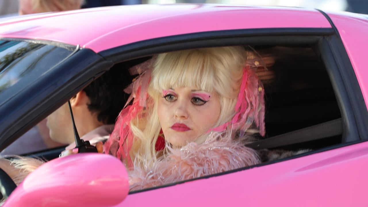 Emmy Rossum is an absolute dead ringer for Angelyne behind the wheel. Picture: Backgrid.