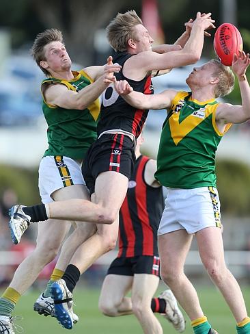 Gippsland Football League Grand Final match between Maffra Eagles and Leongatha Parrots. Maffra became the 2016 premiers, defeating Leongatha 13.10 (88) to 9. 16 (67). Sam Pleming tries to grab the ball in the middle of Christopher Verboon and Patrick McGrath. Picture: Yuri Kouzmin