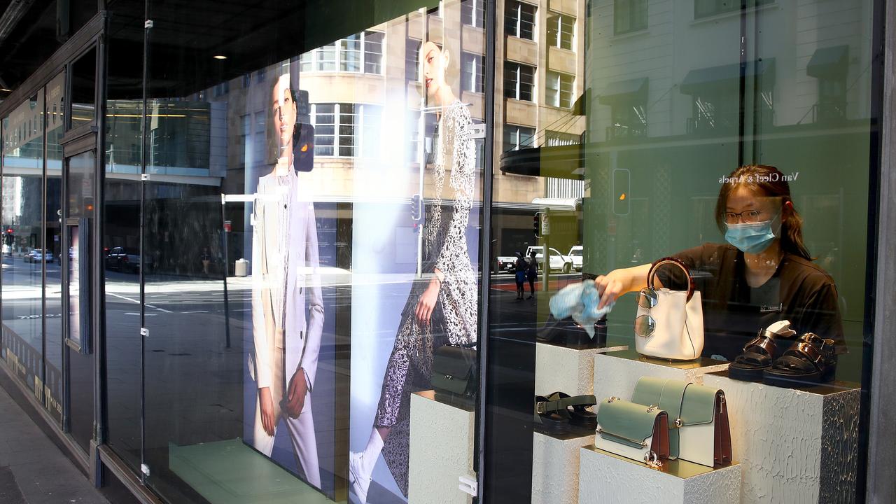 A staff member cleans a window display at David Jones Elizabeth Street store during the height of COVID in the city. Picture: Toby Zerna