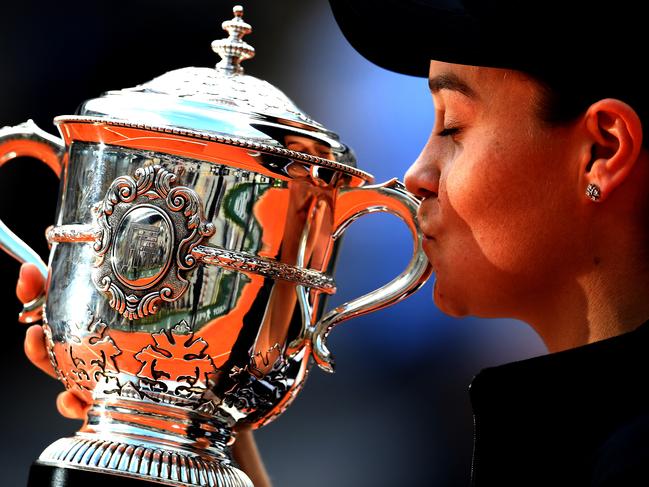 Ashleigh Barty kisses the trophy as she celebrates her first grand slam victory.