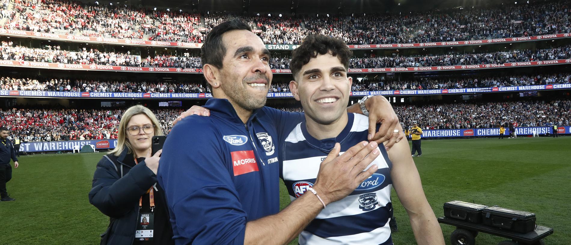 MELBOURNE, AUSTRALIA - SEPTEMBER 24: Geelong Assistant Eddie Betts and Tyson Stengle of the Cats embrace after the 2022 AFL Grand Final match between the Geelong Cats and the Sydney Swans at the Melbourne Cricket Ground on September 24, 2022 in Melbourne, Australia. (Photo by Darrian Traynor/AFL Photos/via Getty Images)