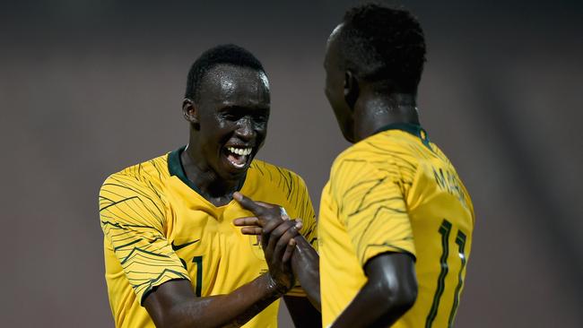 Awer Mabil, right, celebrates his first goal with childhood friend Thomas Deng as they both made their Socceroos debut at Al Kuwait Sports Club Stadium in Kuwait City. Picture: Tom Dulat/Getty Images