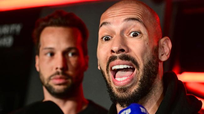 Controversial influencer, alleged rapist and human trafficker Andrew Tate and his brother Tristan speak to the media as they arrive in Romania, where Tate is facing a series of serious charges. Picture: Daniel Mihailescu/AFP