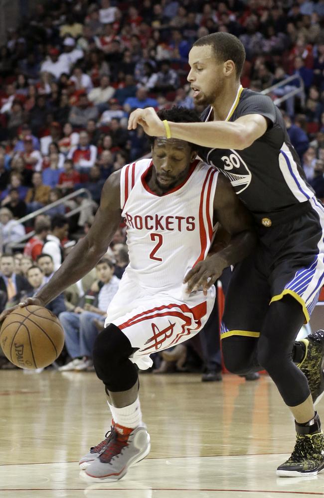 Houston Rockets' Patrick Beverley is pressured by Golden State Warriors' Stephen Curry.