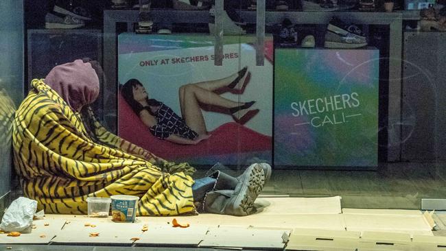 A man takes shelter from the cold in the CBD. Picture: Jake Nowakowski