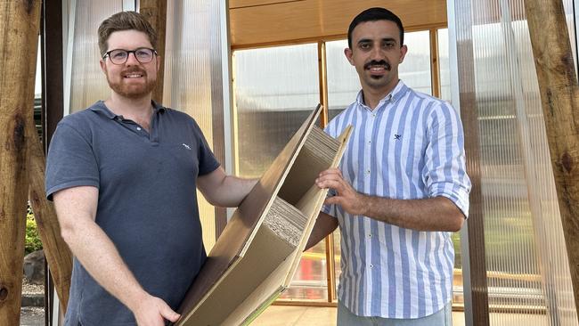 University of Queensland associate professor of civil engineering Joe Gattas and PhD candidate Mahmoud Abu-Saleem with one of the cardboard cores.