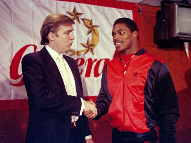 New Jersey Generals owner Donald Trump shakes hands with Herschel Walker after agreeing on a four-year contract. Picture: AP