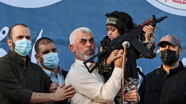 Hamas leader in the Gaza Strip Yahya Sinwar holds the child of an Al-Qassam Brigades fighter, who was killed in the recent fighting with Israel during a rally in Gaza City on May 24. Picture: Mahmud Hams/AFP