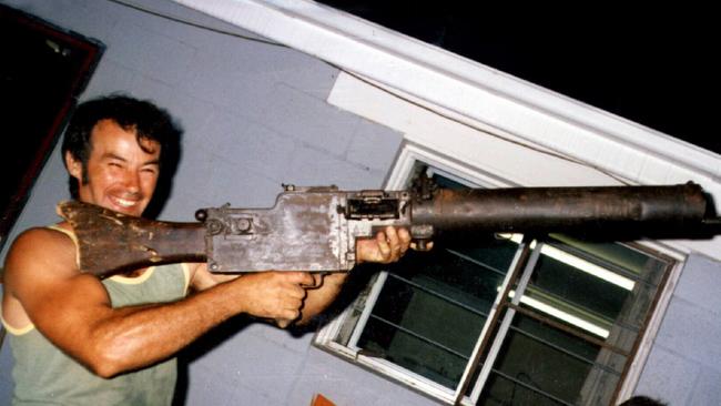 Milat in 1983 aged 39 and holding a WWI vintage machine gun.