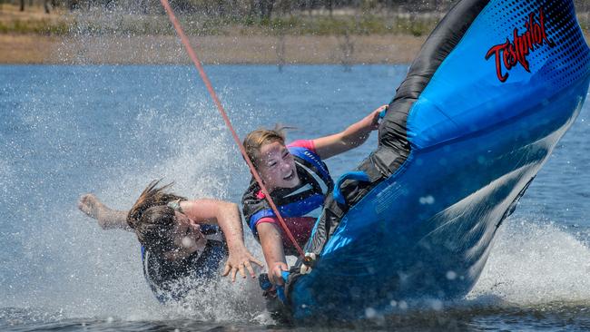 Grace Price and Gracie Tomlin enjoy the lifting of Melbourne’s ‘ring of steel' at Lake Eppalock Holiday Park yesterday. Picture: Jay Town