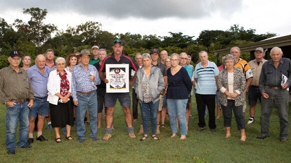 Mark Mason, centre (holding poster), with other concerned landholders and locals at therecent emergency meeting at Moorlands.