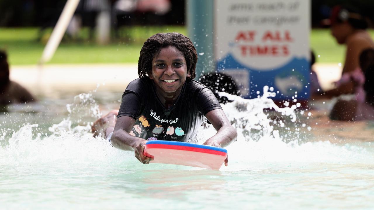 Hot and oppressive summer weather has swept across Far North Queensland, with sunny skies leading to high temperatures. Maxannie Baira, 11, cools off from the hot January weather by jumping into the pool with her kickboard at the Woree Sports and Aquatic Centre. Picture: Brendan Radke