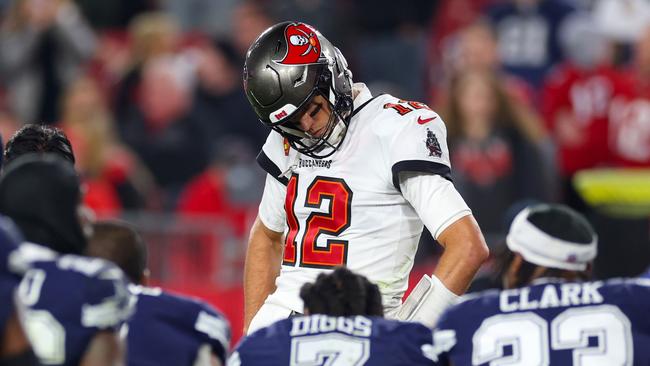 TAMPA, FLORIDA - JANUARY 16: Tom Brady #12 of the Tampa Bay Buccaneers looks on during an injury timeout during the fourth quarter against the Dallas Cowboys in the NFC Wild Card playoff game at Raymond James Stadium on January 16, 2023 in Tampa, Florida. (Photo by Mike Ehrmann/Getty Images)