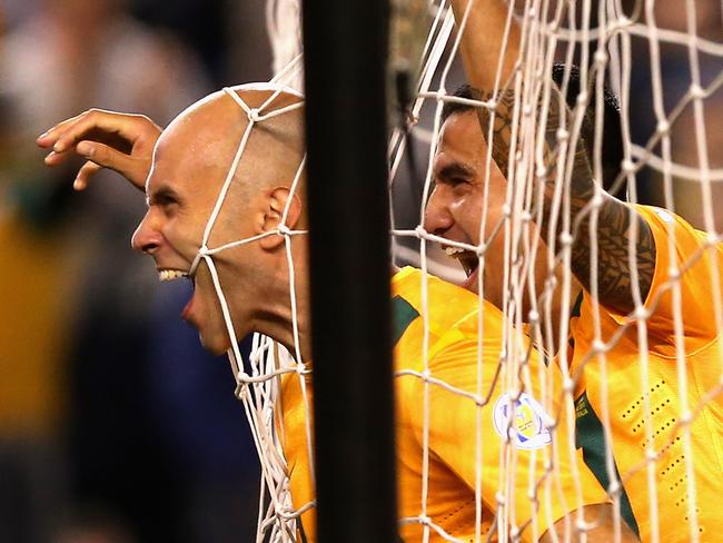 Mark Bresciano and Australia teammate Tim Cahill rejoice.