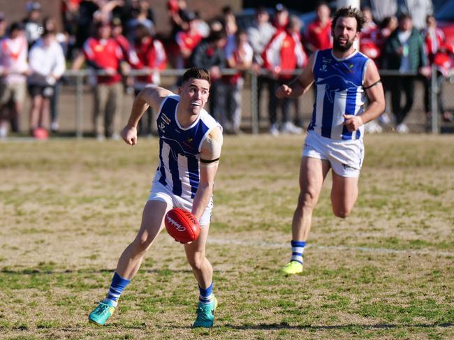 Langwarrin's Joel Bateman fires off a handball in front of teammate Jarryd Amalfi. Picture: Paul Stan Churcher