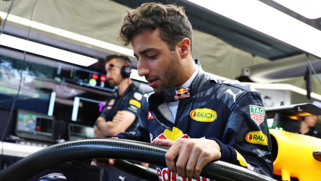 Daniel Ricciardo climbs into his car fitted with the halo.