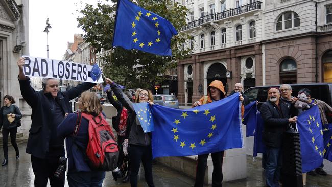 Pro-EU membership supporters argue with a leave campaigner outside the High Court, where lawyers are battling over whether the government has the power to trigger Britain's exit from the European Union without approval from Parliament. Picture: Frank Augstein/AP