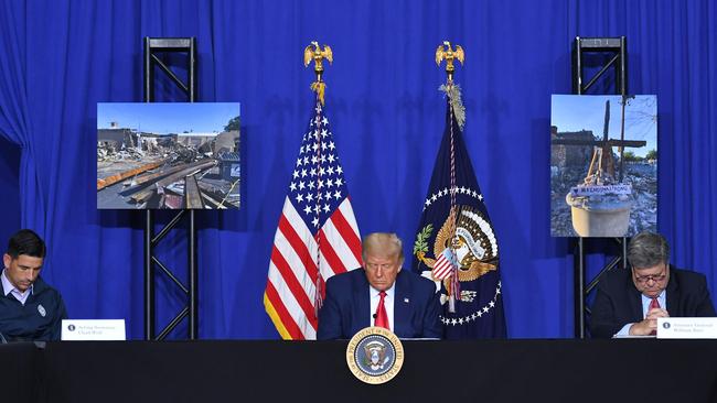 Donald Trump (C) with US Attorney General William Barr (R) and Acting Homeland Security Secretary Chad Wolf (L), bows his head in prayer during a roundtable discussion on community safety, at Mary D. Bradford High School in Kenosha. Picture: AFP.