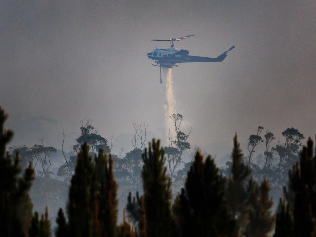 Water bombing helicopter helping to fight the fire in Landsborough late on Sunday afternoon. Picture: Lachie Millard