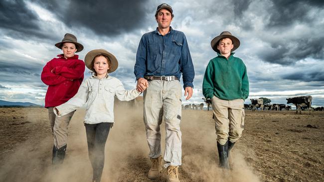Whorouly dairy farmer Jon Pethybridge and his children Owen 12, Molly 10, and Nora 6, are desperate for rain as their paddocks are turning into dust bowls. Picture: Simon Dallinger