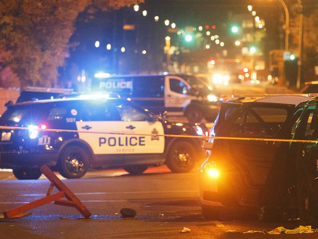 Police investigate the scene where a car crashed into a roadblock in Edmonton. Picture: Jason Franson/The Canadian Press via AP