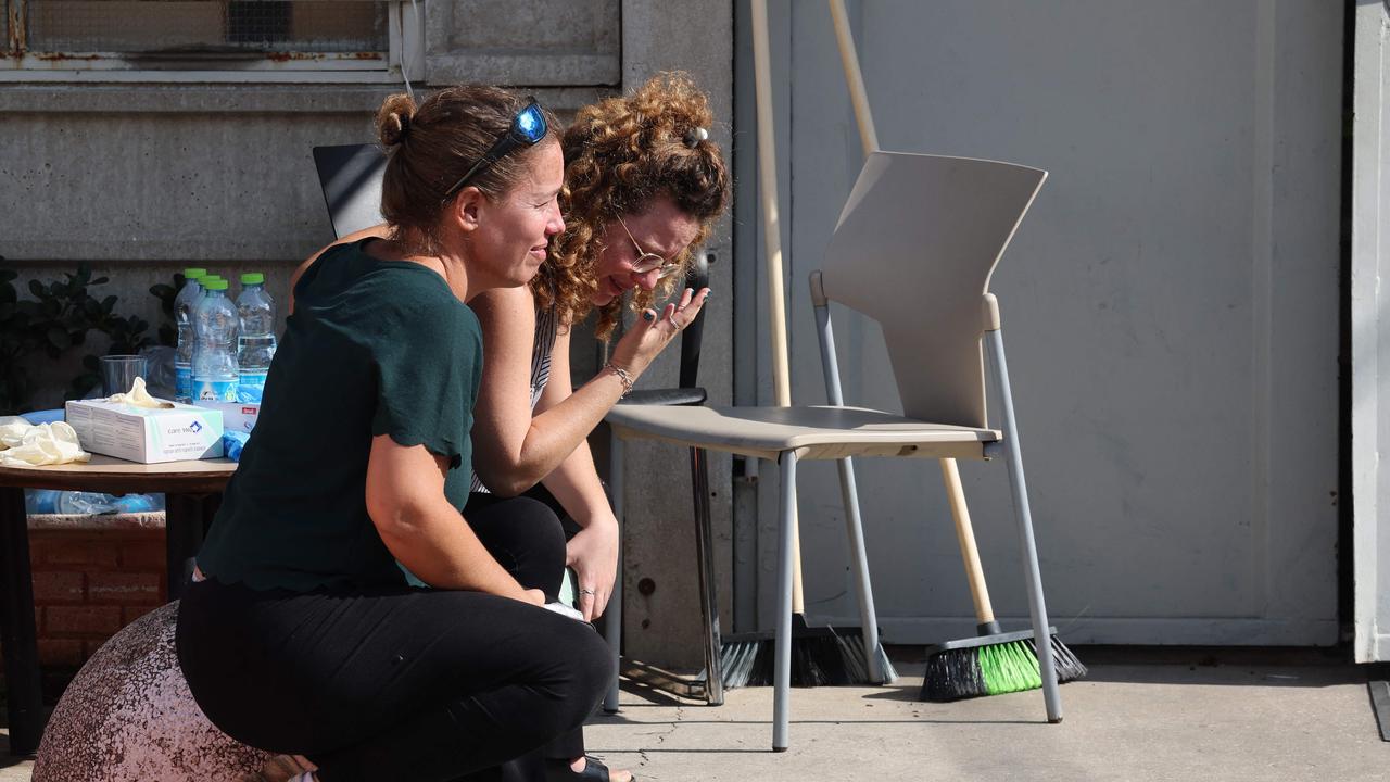 Relatives mourn as they wait for the body of a relative at the National Centre for Forensic Medicine in Tel Aviv. Picture: AFP