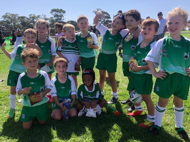 Coogee Randwick Wombats U6s celebrate after winning the South Sydney District Junior Rugby League division one rugby grand final.